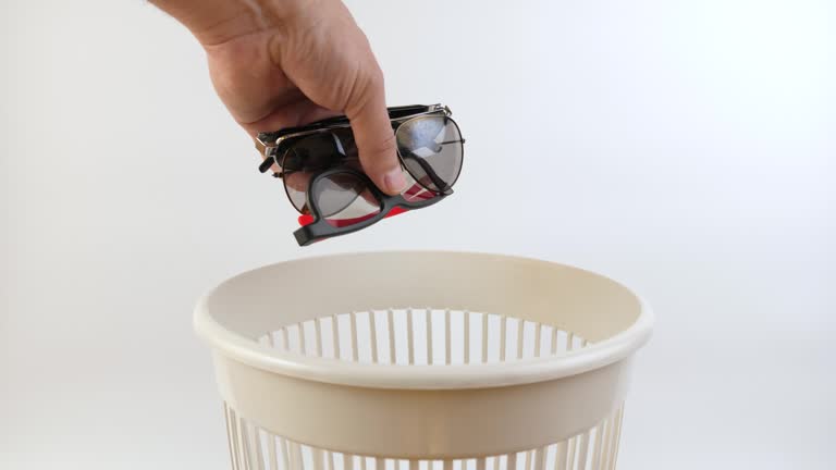 Old glasses are thrown into the trash can. Disposal of household waste. Slow motion