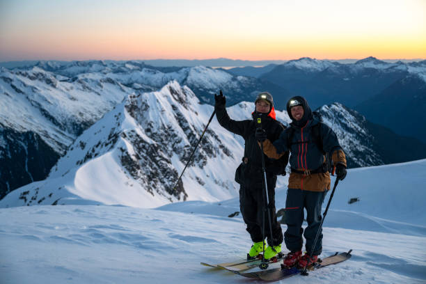 istock Ski mountaineers pause on mountain at twilight 2150646467