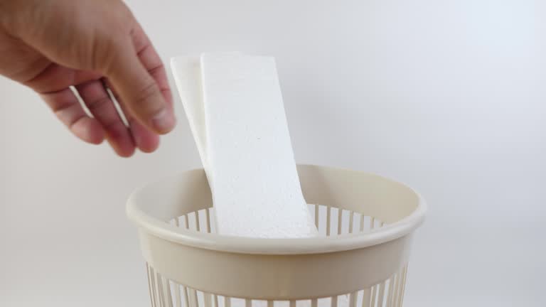 Pieces of Styrofoam are thrown into the trash can. Disposal of household waste. Slow motion