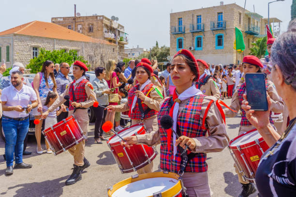 Haifa, Israel - April 28, 2024: Scouts and others take part in the Easter Palm Sunday parade of the Greek Orthodox community, in Downtown Haifa, Israel
