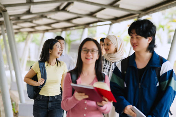 istock Group Of Asian Students Walking In School Corridor. 2150648123