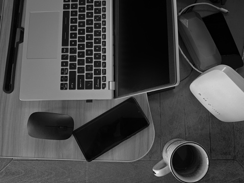 this photo capture the blend of professional and creative elements in a modern workspace, all captured in a stylish black and white photograph.