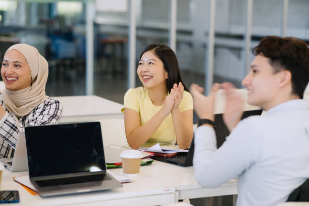 istock Happy students applauding in class to a speaker. 2150648302