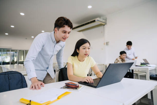 istock Teenage classmate discussing their assignment in classroom 2150648420