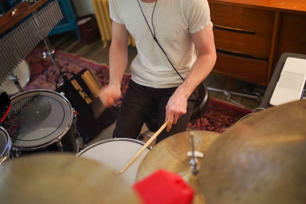 istock High angle view closeup of drummer's hands playing in home studio cymbals drums chimes 2150648806