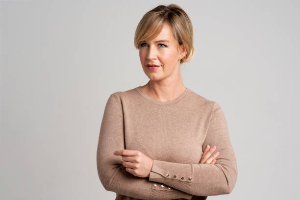istock Blond haired woman wearing sweater and standing at isolated background 2150652973