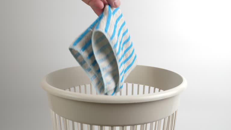 The kitchen towel is thrown into the trash can. Disposal of household waste. Slow motion