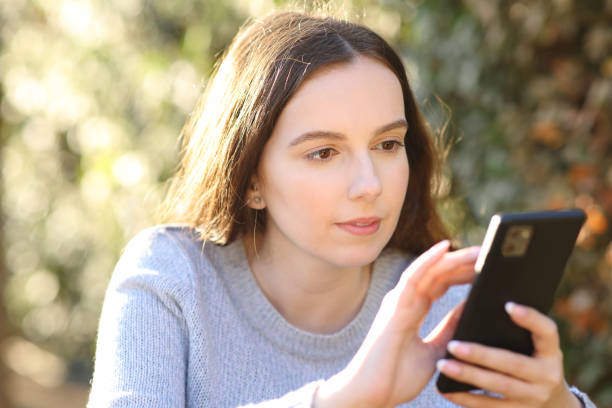 istock Happy woman using smart phone in a garden 2150654473