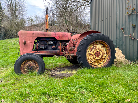 Old vintage red farm tractor