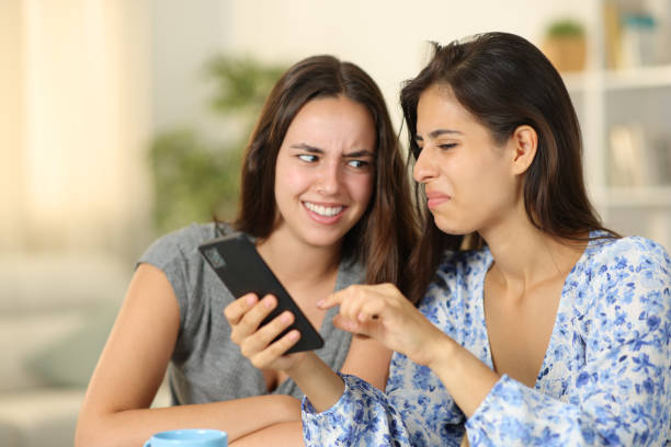 istock Disgusted women watching nasty content on phone 2150654722