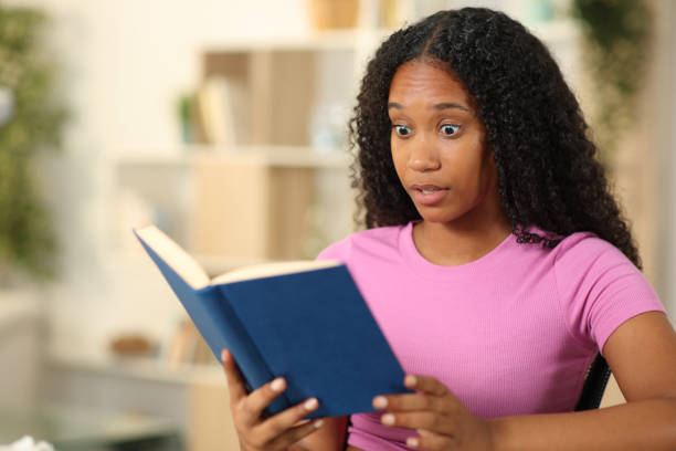 istock Amazed black woman reading a paper book 2150654831