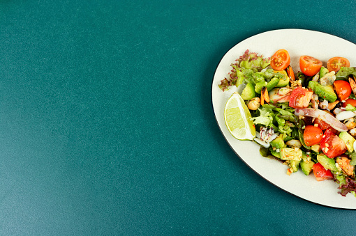 Salad with calamari, shrimp, clams and fresh vegetables. Copy space.