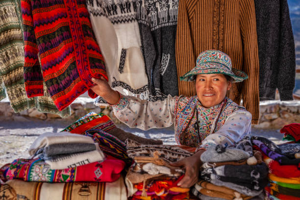 Peruvian woman selling souvenirs in her shop near Colca Canyon, Peru. Colca Canyon is a canyon of the Colca River in southern Peru. It is located about 100 miles (160 kilometers) northwest of Arequipa. It is more than twice as deep as the Grand Canyon in the United States at 4,160 m. However, the canyon's walls are not as vertical as those of the Grand Canyon. The Colca Valley is a colorful Andean valley with towns founded in Spanish Colonial times and formerly inhabited by the Collaguas and the Cabanas. The local people still maintain ancestral traditions and continue to cultivate the pre-Inca stepped terraces.