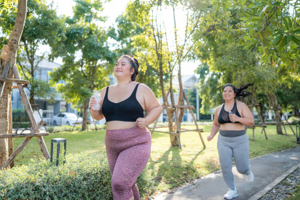 istock Happy plus size asian woman running in a park . 2150658173
