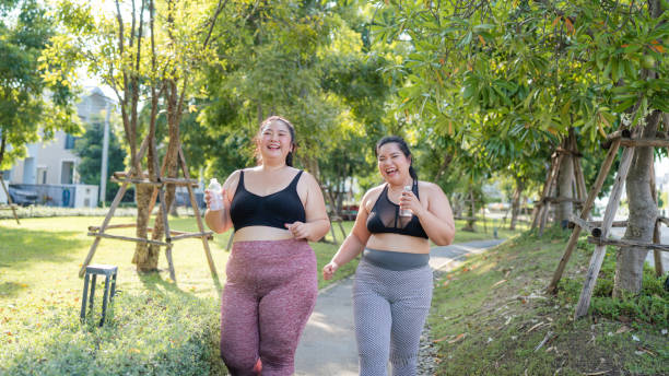 istock Happy plus size asian woman running in a park . 2150658258