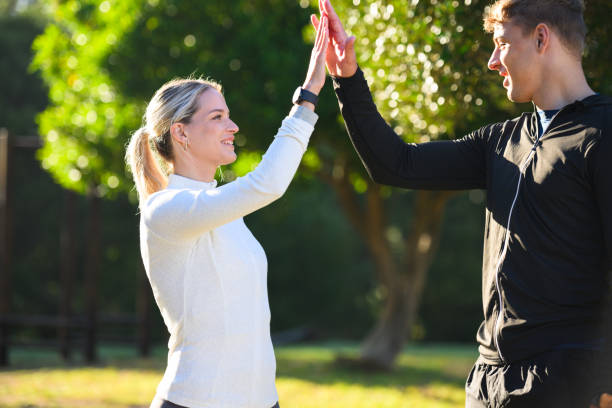 istock Couple high-five exercising in park together 2150660183