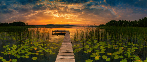 istock Serene lake sunset with wooden jetty 2150663225