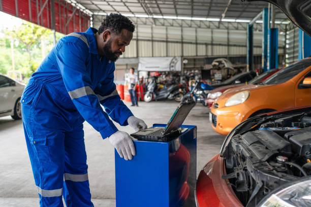 istock Auto mechanic in blue uniform are repair and maintenance auto engine is problems. 2150663397