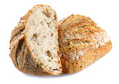 A loaf of bread cut in half with seeds isolated on a white background. Art bread.