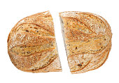 A loaf of bread cut in half with seeds isolated on a white background. Art bread.