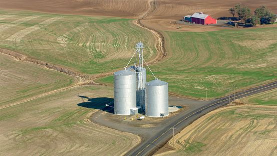 Aerial view of large silver coloured silos on agricultural field at Walla Walla in Washington State, USA.