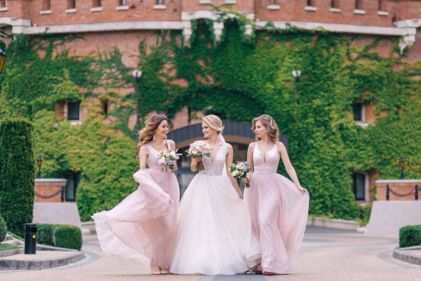 Pretty bridesmaids surround a bride holding wedding bouquets in
