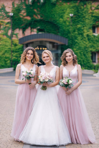 istock Bride with bridesmaids in park on wedding day 2150665852