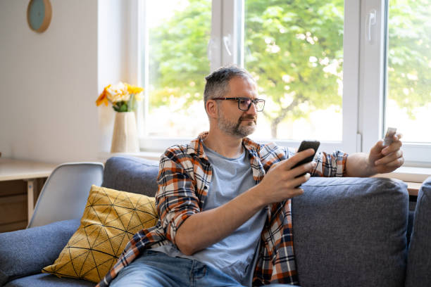 Man typing his social security number over a mobile phone from home