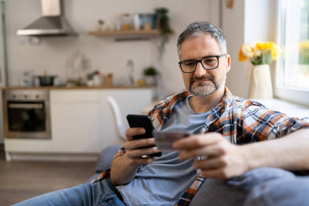 istock Man typing his social security number over a mobile phone from home 2150667064