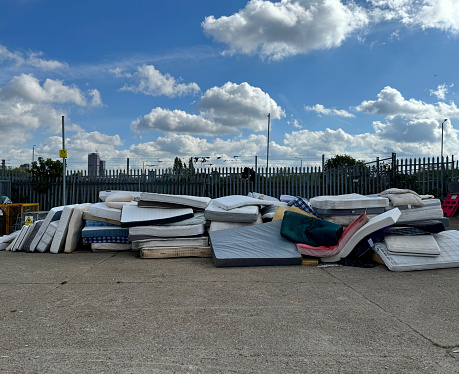 Pile of old mattresses at a recycling centre