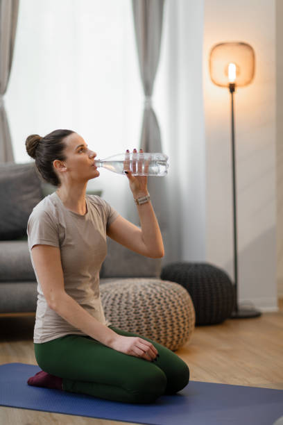 istock Young woman drinking water after exercise 2150669986