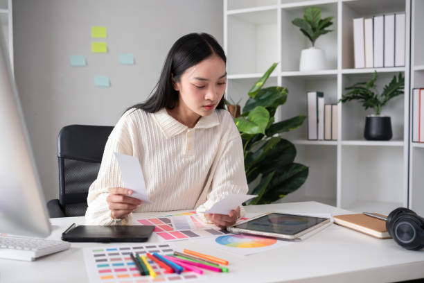 istock Female designer working in graphic design Choose colors for working on tablets and computer designs. 2150670443