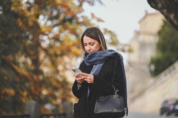 istock Business woman reading messages after work on mobile phone. 2150670453