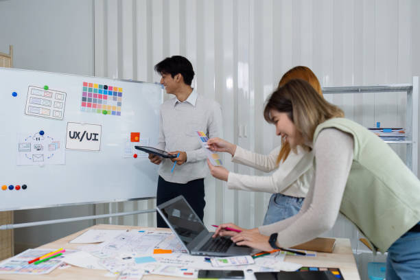 istock UI designers present to team about color design of logo during application design brainstorming. Creative digital development agency. UX UI concept 2150671243