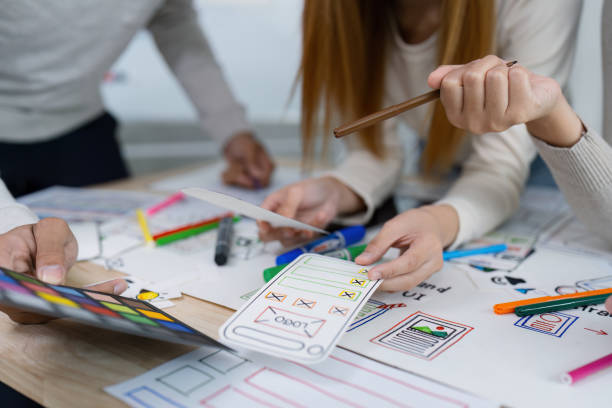 istock UI designer and UX developer brainstorm idea to design the application appearance in the early stage. Creative digital development agency. UX UI concept 2150671321