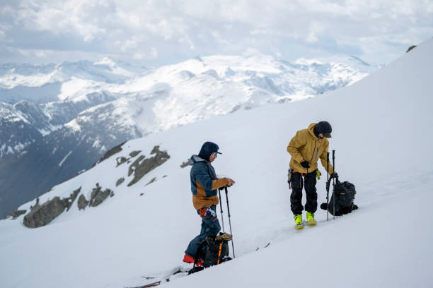 istock Backcountry skiers prepare to ski down mountain 2150672075