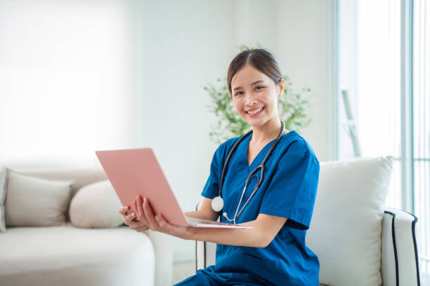 istock Female Doctor Wearing white Coat with Stethoscope Using laptop. 2150672144