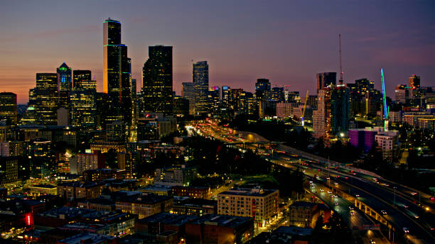 Seattle Washington downtown cityscape at night time. Shot in the summer of 2022, with copy space over the city skyscrapers.