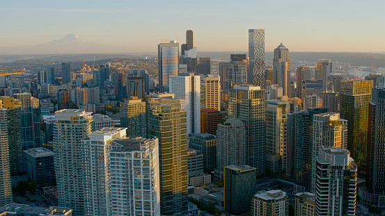 Aerial view of cityscape with modern skyscrapers at Denny Triangle neighbourhood in Seattle during sunset, Washington State, USA.