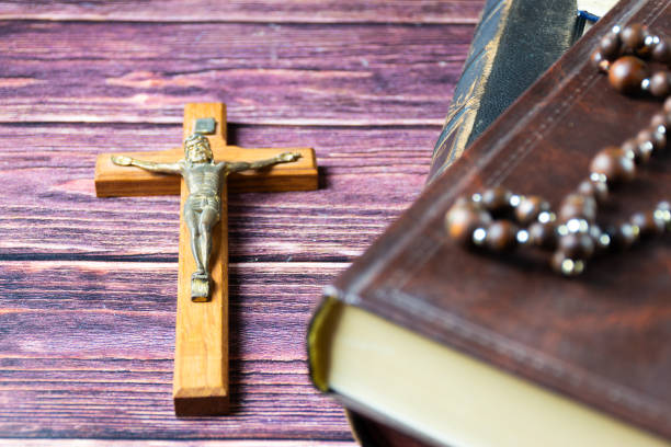 istock Crucifix and holy bible on a table 2150672314