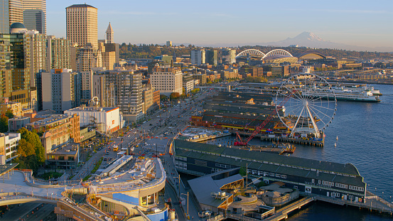 Aerial view of Seattle Waterfront and Seattle Great Wheel at sunset with mount Rainier in background, Seattle, Washington State, USA.