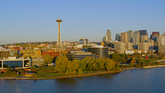 Aerial view of Space Needle with cityscape against sky at sunset along the waterfront, Alaskan Way, Seattle, Washington State, USA.