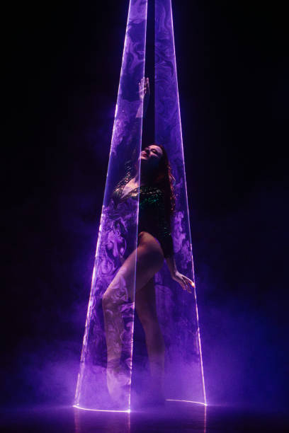 istock Ballet dancer in pointe under multicolor neon laser light on stage. Woman ballerina posing in dark room. Performance, projection mapping. Interactive installation, Optical visuals concept 2150674220
