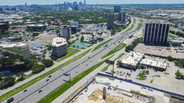 istock Aerial view construction site wooden framing next to Stemmons Freeway Interstate Highway I-35E, business park in Northwest Dallas, group of office buildings, hotels downtown skylines background 2150675865