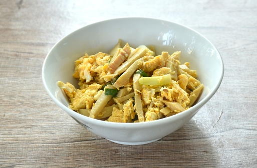 stir fried bamboo shoot and egg with spring onion on bowl