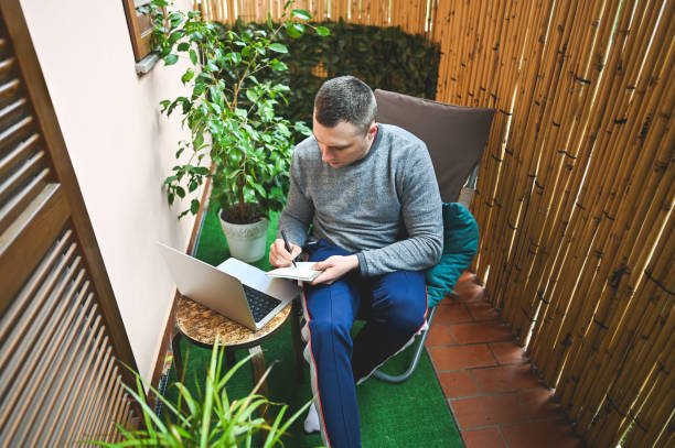 istock Man working at home office in a yard. 2150676492