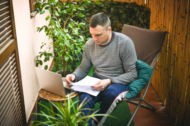 istock Mid adult man working with paper documents at home. 2150676514