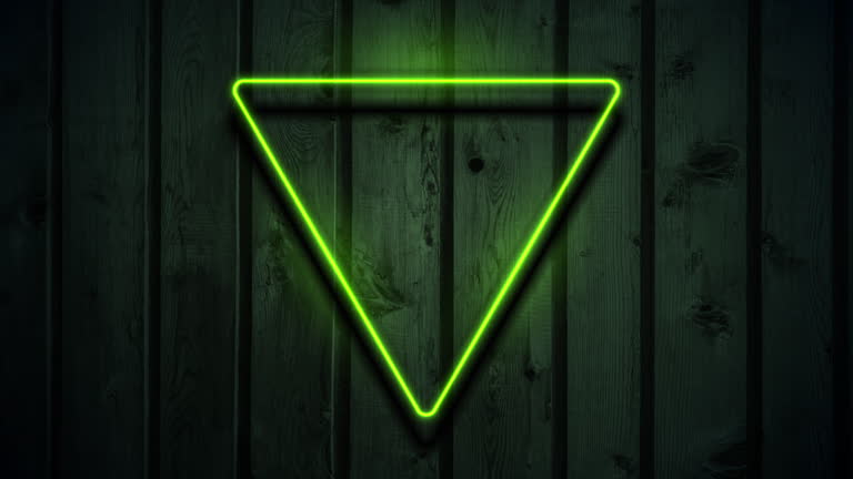 Green neon luminous triangular frame on dark wooden abstract background