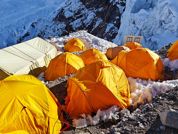 istock Himalayan mountain camp in Nepal, colorful tents, glacier, and clouds 2150677019
