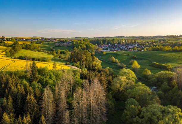 istock Drone flies over countryside with green field. 2150677396